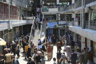 Afghans walk around a downtown currency exchange market in Kabul, Afghanistan, Monday, April 22, 2024. (AP Photo/Siddiqullah Alizai)