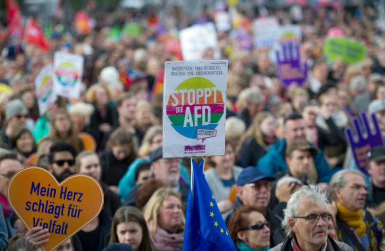 A protestor holds up a sign reading "Stop the AFD" during a demonstration in Berlin on October 22, 2017 as representatives of the far-right party prepare to take their seats in German parliament next week