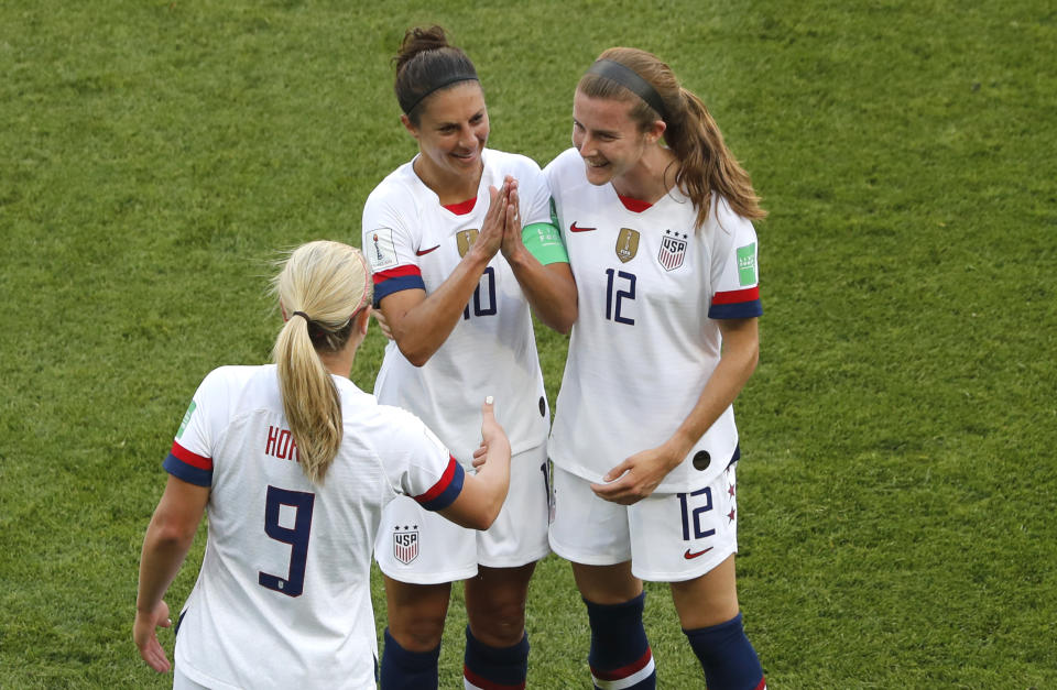 United States' Carli Lloyd , center, celebrates with Lindsey Horan and Tierna Davidson, right, after scoring the opening goal during the Women's World Cup Group F soccer match between the United States and Chile at the Parc des Princes in Paris, Sunday, June 16, 2019. (AP Photo/Thibault Camus)