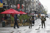 Belgian soldiers and a police officer patrol in central Brussels, November 21, 2015. REUTERS/Youssef Boudlal