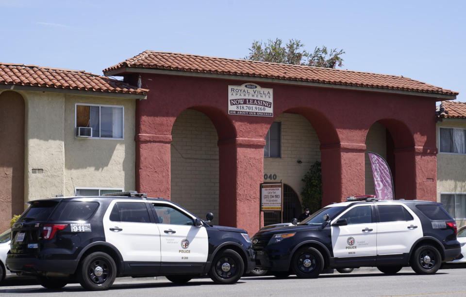 Los Angeles Police investigate the scene of a crime at the Royal Villa apartments complex in Reseda, Calif., Saturday, April 10, 2021. A woman discovered her three grandchildren, all under the age of 5, slain inside a Los Angeles apartment Saturday morning and their mother gone, police said. The mother of three children — all under the age of 5 — found slain inside a Los Angeles apartment Saturday morning has been arrested, police said. (AP Photo/Damian Dovarganes)