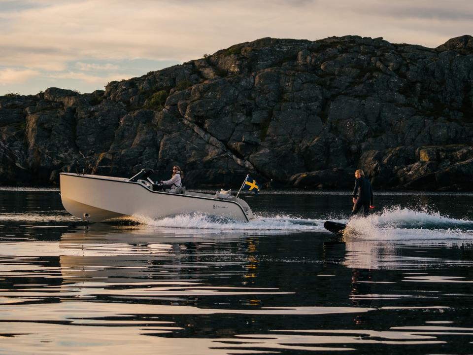 A view of the boat tracking a man on a surf board.