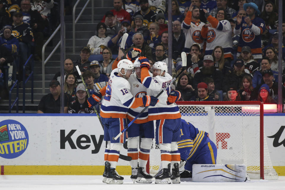 New York Islanders right wing Josh Bailey (12), center Brock Nelson (29) and left wing Anthony Beauvillier (18) celebrate after a goal by Nelson against the Buffalo Sabres during the first period of an NHL hockey game Thursday, Jan. 19, 2023, in Buffalo, N.Y. (AP Photo/Joshua Bessex)