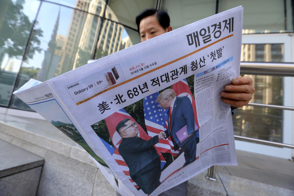 In this June 12, 2018, file photo, a man reads a newspaper reporting the summit between U.S. President Donald Trump and North Korean leader Kim Jong Un, at a newspaper distributing station in Seoul, South Korea. Trump and Kim are planning a second summit in the Vietnam capital of Hanoi, Feb. 27-28. The headline read: " North Korea and the United States end 68 years of hostile relations." (AP Photo/Ahn Young-joon, File)