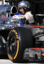 McLaren Formula One driver Jenson Button of Britain waits in the pit during the U.S. F1 Grand Prix at the Circuit of the Americas in Austin, Texas November 17, 2013.