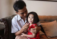 Reuters reporter Kyaw Soe Oo celebrates with his daughter after being freed from prison, after receiving a presidential pardon in Yangon, Myanmar, May 7, 2019. REUTERS/Ann Wang/Pool