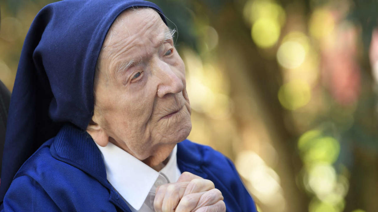 (FILES) In this file photo taken on February 10, 2021, Sister Andre, Lucile Randon in the registry of birth, the eldest French and European citizen, prays in a wheelchair, on the eve of her 117th birthday, in an EHPAD (Housing Establishment for Dependant Elderly People) in Toulon, southern France, where she has been living since 2009. - The world's oldest known person, Lucile Randon, known as Sister Andre, has died aged 118, her spokesman said on January 17, 2023. Randon was born in southern France on February 11, 1904, when World War I was still a decade away. (Photo by NICOLAS TUCAT / AFP)