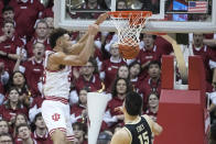 Indiana's Trayce Jackson-Davis, left, dunks against Purdue's Zach Edey (15) during the first half of an NCAA college basketball game, Saturday, Feb. 4, 2023, in Bloomington, Ind. (AP Photo/Darron Cummings)