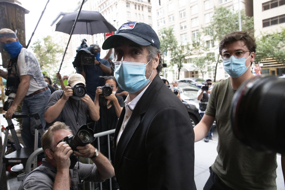 Michael Cohen, President Donald Trump's former personal attorney, returns to his apartment after being released from prison, Friday, July 24, 2020, in New York. District Judge Alvin Hellerstein ordered Cohen released on parole saying he believes the government retaliated against him for writing a book about Trump. (AP Photo/Mark Lennihan)