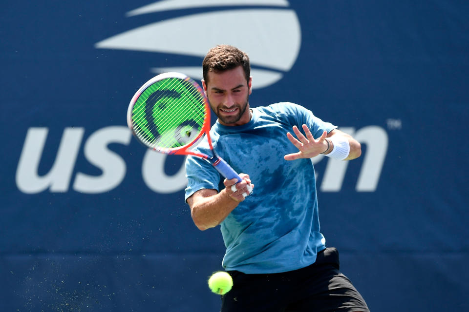 Noah Rubin hits a forehand during his men's singles first round match.