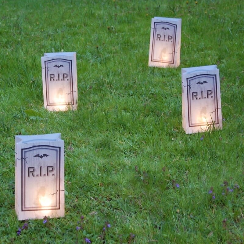 Four of the tombstone lights lit up in a yard