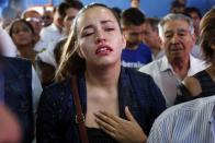 A relative cries as she attends the wake of Rodrigo Quintana, a member of the Authentic Radical Liberal Party who was killed in an incident at party's headquarters away from congress at the party's headquarters on Friday, in Asuncion, Paraguay, Saturday, April 1, 2017. Clashes erupt between police and protesters outside Paraguay's congress, with demonstrators setting fires around the building after a majority of senators carry out what some was called an irregular vote to allow presidential re-election. (AP Photo/Jorge Saenz)