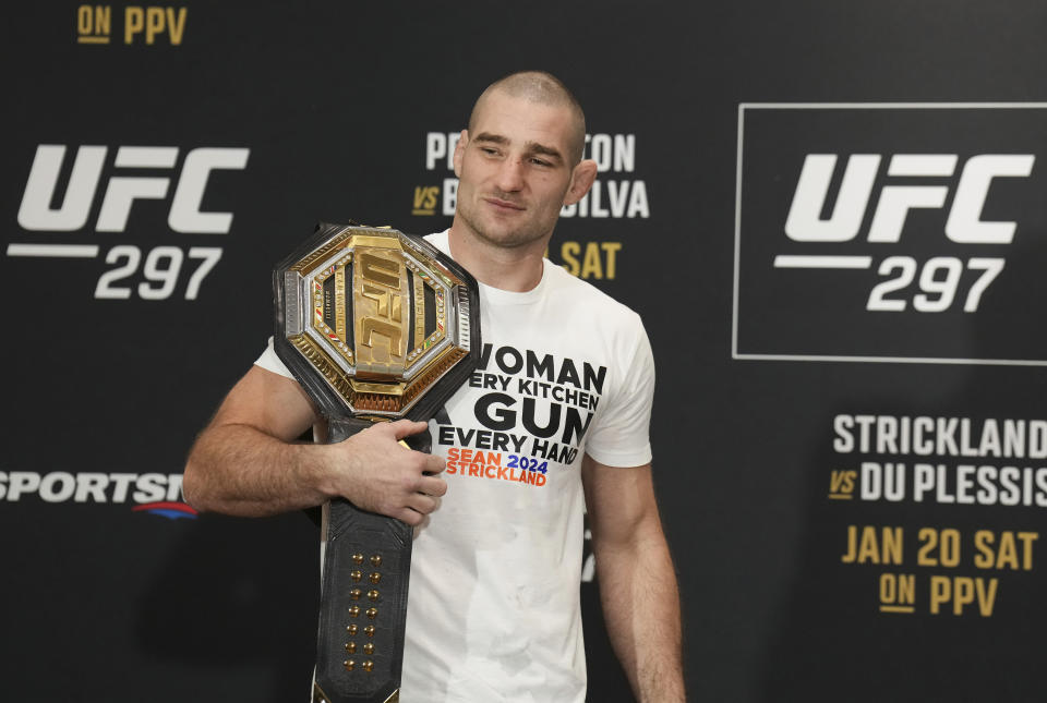 UFC middleweight champion Sean Strickland poses after speaking ahead of UFC 297 in Toronto Wednesday, Jan. 17, 2024. (Nathan Denette/The Canadian Press via AP)