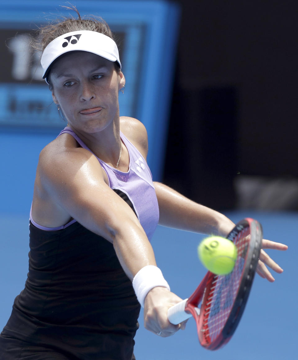 Germany's Tatjana Maria makes a backhand return to United States' Serena Williams during their first round match at the Australian Open tennis championships in Melbourne, Australia, Tuesday, Jan. 15, 2019. (AP Photo/Kin Cheung)