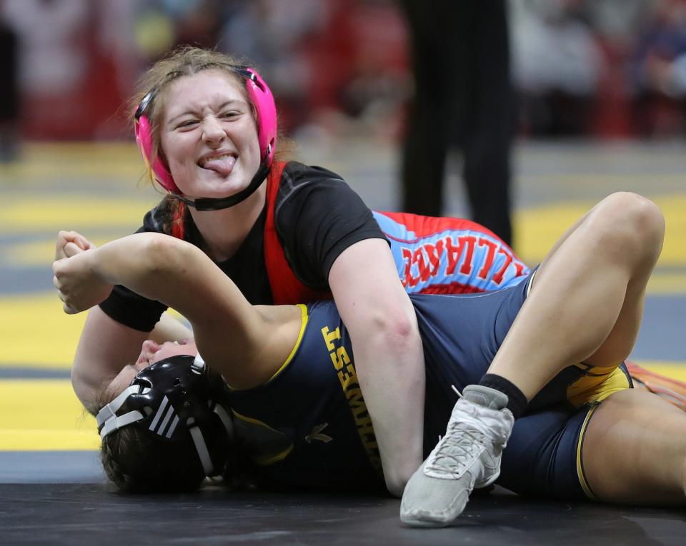 Abigail Mozden of Alliance, top, celebrates as she pins Olivia Gilliand of Cincinnati Northwest Friday at the state meet.