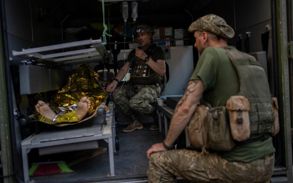 An injured Ukrainian servicemen is transferred to a medical facility after getting emergency treatment in Bakhmut, eastern Ukraine, on June 7, 2022.  - Bernat Armangue/AP