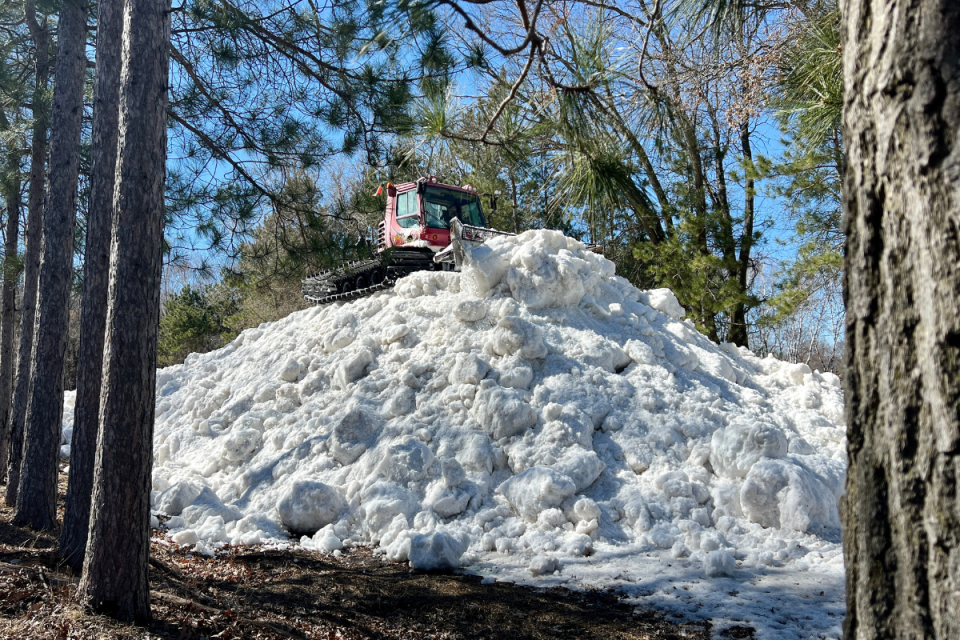 A snowcat perches atop a mound of snow at Trollhaugen.<p>Trollhaugen Ski Area</p>