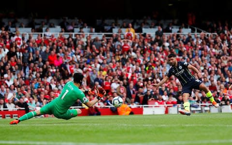Sergio Aguero has a shot saved by Arsenal's Petr Cech - Credit: REUTERS