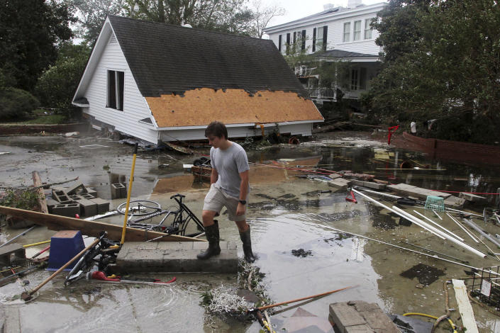 <p>Resident Joseph Eudi looks at flood debris and storm damage from Hurricane Florence at a home on East Front Street in New Bern, N.C., Saturday, Sept. 15, 2018. (Photo: Gray Whitley/Sun Journal via AP) </p>