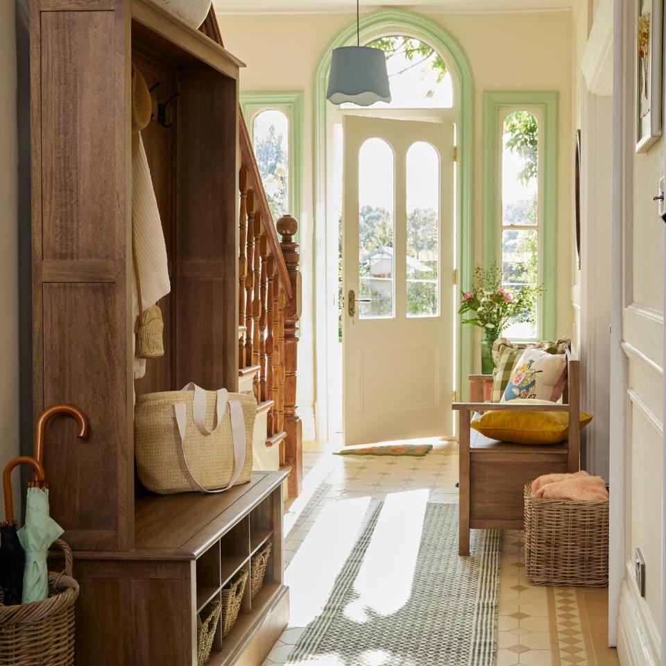  Bright hallway with blue runner rug. 