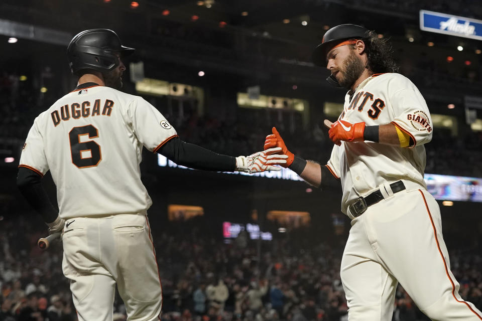 San Francisco Giants' Brandon Crawford, right, is congratulated by Steven Duggar after scoring a run against the San Diego Padres during the second inning of a baseball game in San Francisco, Wednesday, Sept. 15, 2021. (AP Photo/Jeff Chiu)