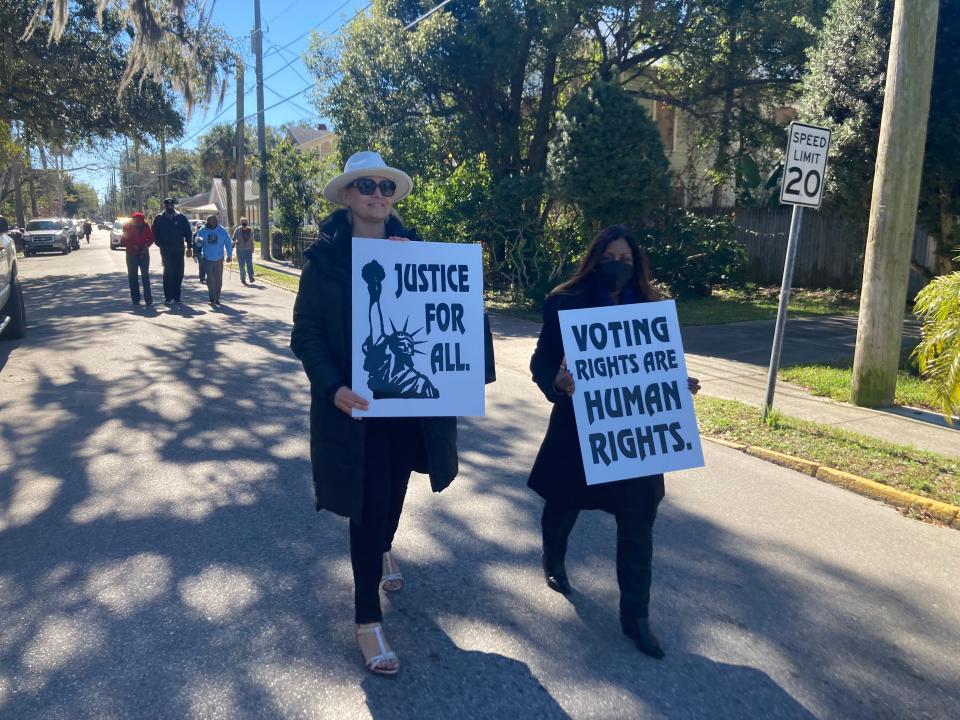 Jacksonville educators Tricia Finkenberg and Deborah Cannington walk on Dr. Martin Luther King Jr. Avenue in St. Augustine during a march on Martin Luther King Jr. Day.
