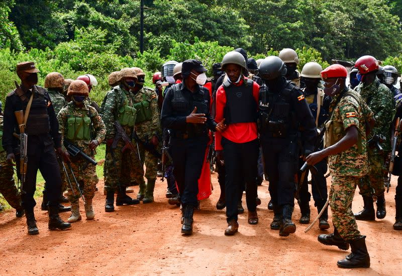 Uganda opposition presidential candidate Robert Kyagulanyi is escorted by police in Kalangala