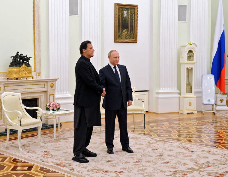 Russian President Vladimir Putin shakes hands with Pakistan's Prime Minister Imran Khan during a meeting in Moscow