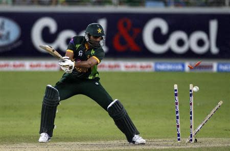 Pakistan's Sohail Tanvir is bowled during their second Twenty20 international cricket match against South Africa in Dubai November 15, 2013. REUTERS/Nikhil Monteiro