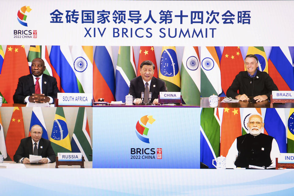 FILE - In this photo released by Xinhua News Agency, Chinese President Xi Jinping is seen on a screen with South African President Cyril Ramaphosa, Brazilian President Jair Bolsonaro, Russian President Vladimir Putin and Indian Prime Minister Narendra Modi as he hosts the 14th BRICS Summit via video link from Beijing, on June 23, 2022. By ending 77 years of almost uninterrupted peace in Europe, war in Ukraine war has joined the dawn of the nuclear age and the birth of manned spaceflight as a watershed in history. After nearly a half-year of fighting, tens of thousands of dead and wounded on both sides, massive disruptions to supplies of energy, food and financial stability, the world is no longer as it was. (Li Tao/Xinhua via AP)