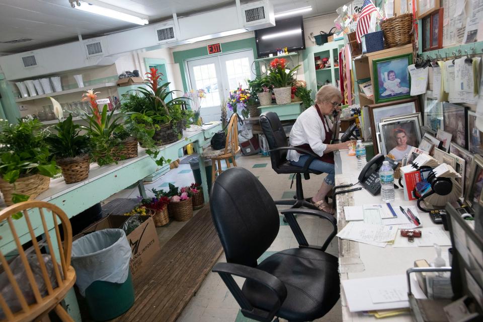 Grandview Florist employee Kathy Elliott handles phone orders from customers in the days leading up to Mother's Day. The Escambia County business marked its 100th anniversary earlier this month.