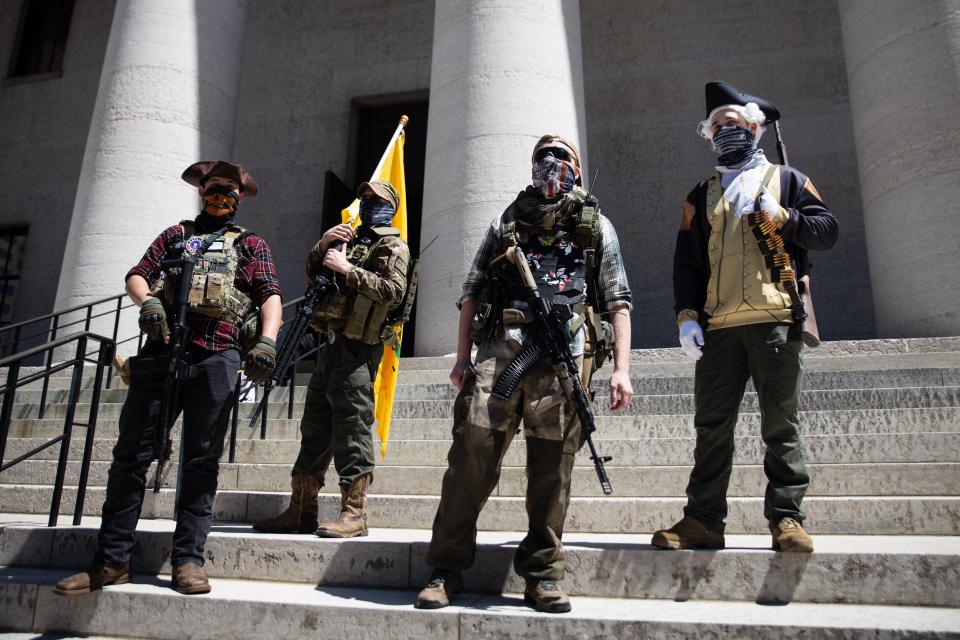 A local militia group is seen at a rally to protest the stay-at-home order amid the Coronavirus pandemic in Columbus, Ohio, on April 20. For the third time in the last week, hundreds of protesters gathered at the Ohio State House to protest the stay home order that is in effect until May 1. (Photo: MEGAN JELINGER via Getty Images)