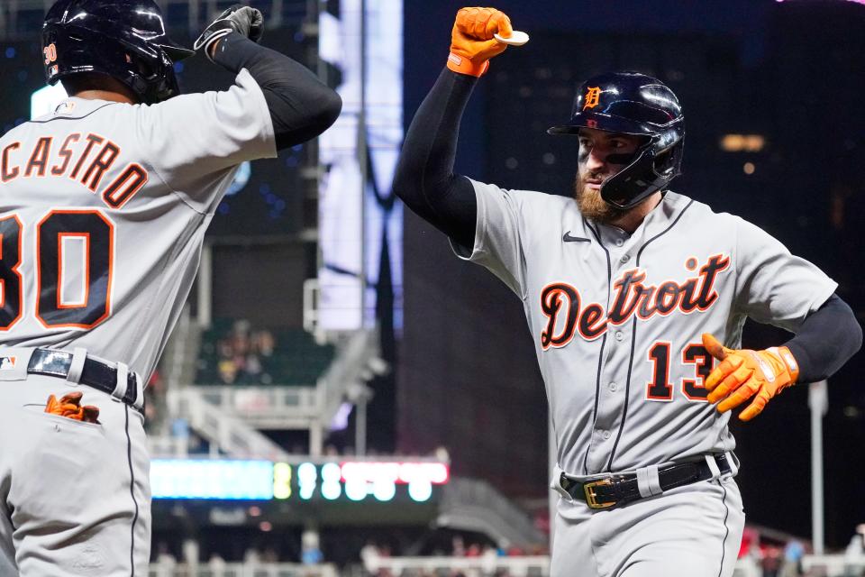 Tigers catcher Eric Haase gets congratulated by shortstop Harold Castro after Haase's solo home run off Twins pitcher Tyler Duffey in the seventh inning of the Tigers' 6-5 loss in 10 innings on Monday, July 26, 2021, in Minneapolis.