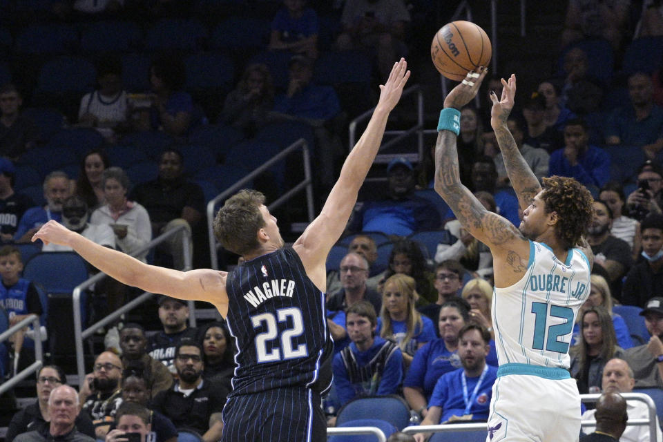 Charlotte Hornets guard Kelly Oubre Jr. (12) goes up for a shot in front of Orlando Magic forward Franz Wagner (22) during the first half of an NBA basketball game, Friday, Oct. 28, 2022, in Orlando, Fla. (AP Photo/Phelan M. Ebenhack)