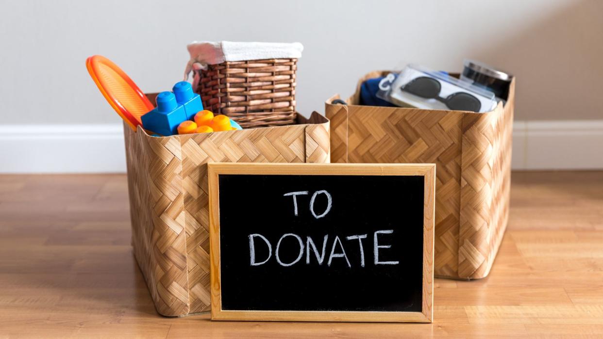  Two boxes full of things behind a donate sign 