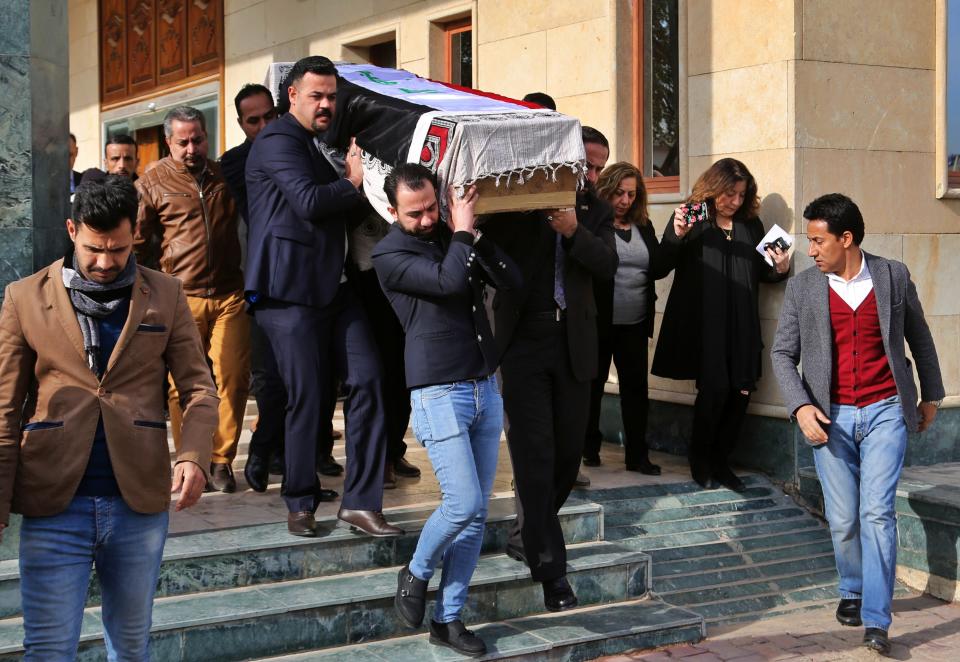 Mourners carry the flag-draped coffin of Iraqi archaeologist, Lamia al-Gailani, for burial during her funeral procession in the National Museum in Baghdad, Iraq, Monday, Jan. 21, 2019. Iraq is mourning the loss of a beloved archaeologist who helped rebuild her country's leading museum in the aftermath of the U.S. invasion in 2003. (AP Photo/Khalid Mohammed)