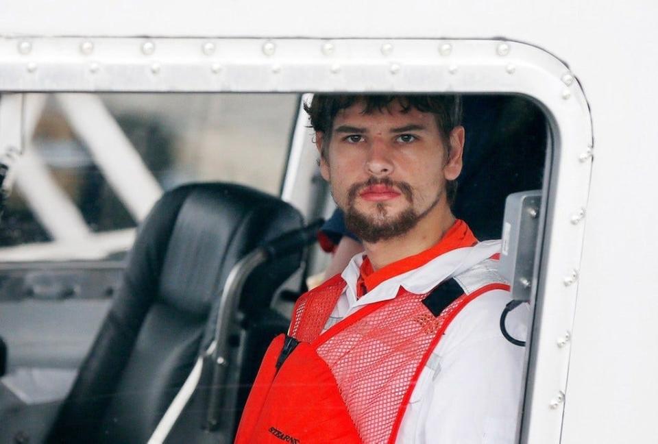 Nathan Carman, rescued from a life raft after the death of his mother and the sinking of his fishing boat off the coast of Rhode Island, arrives at the U.S. Coast Guard station in Boston on Sept. 27, 2016.