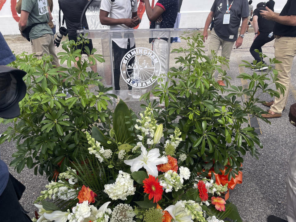 A Flower display is seen at the ceremony for the unveiling of Willie Mays' mural Wednesday, June 19, 2024 in downtown Birmingham, Ala. A mural honoring baseball Hall of Famer Willie Mays has been unveiled in downtown Birmingham, Alabama. Mays died Tuesday at the age of 93. (AP Photo/Alanis Thames).