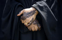 A woman with henna on her hands mourns the five people killed in a car crash on Lake Street, during the funeral at the Dar Al-Farooq Islamic Center in Bloomington, Minn., on Monday, June 19, 2023. (Elizabeth Flores/Star Tribune via AP)