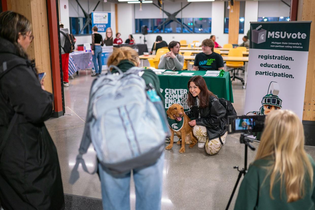 MSU students and community members take photos with ÒZeke the WonderdogÓ during a voter registration event at Michigan State University on Feb. 6, 2024.