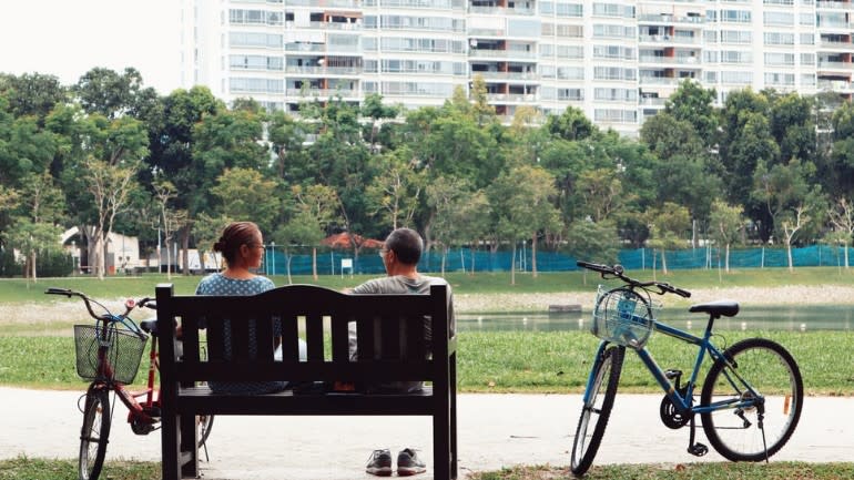 Elderly couple sitting on a bench at Bedok Reservoir Park