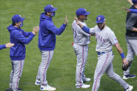 Texas Rangers' Joey Gallo, right, goes through the celebration line after making a diving catch of a ball off the bat of Minnesota Twins' Miguel Sano to end the baseball game in 10 innings Thursday, May 6, 2021, in Minneapolis. (AP Photo/Jim Mone)