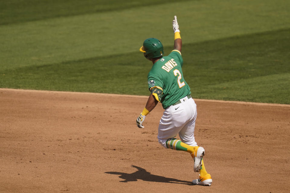 Oakland Athletics' Khris Davis rounds the bases after hitting a solo home run during the fourth inning of Game 2 of an American League wild-card baseball series against the Chicago White Sox, Wednesday, Sept. 30, 2020, in Oakland, Calif. (AP Photo/Eric Risberg)