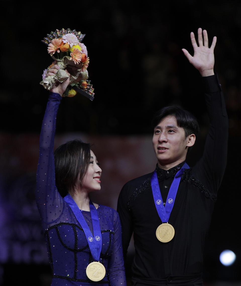 China's Sui Wenjing and Han Cong acknowledge the crowd after winning gold for the pairs free skate during the ISU World Figure Skating Championships at Saitama Super Arena in Saitama, north of Tokyo, Thursday, March 21, 2019. (AP Photo/Andy Wong)