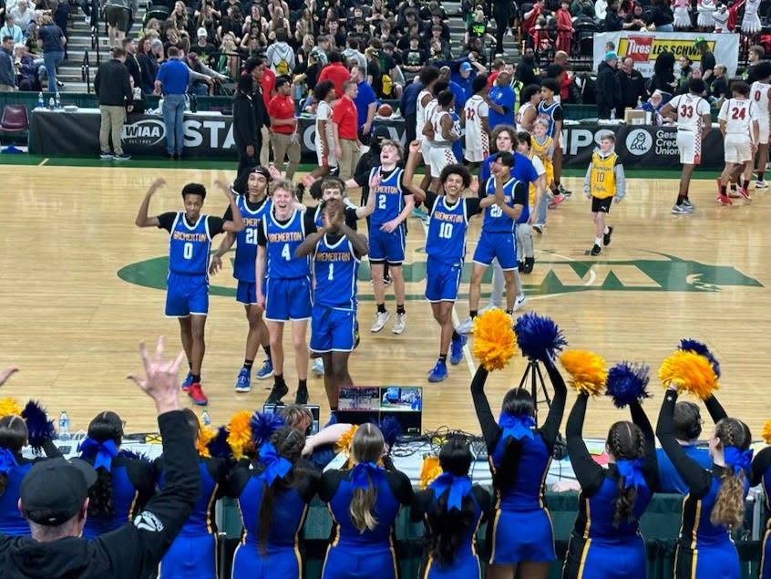 Bremerton’s players react to the crowd at the Yakima Sun Dome after a quarterfinal win against Renton Thursday.