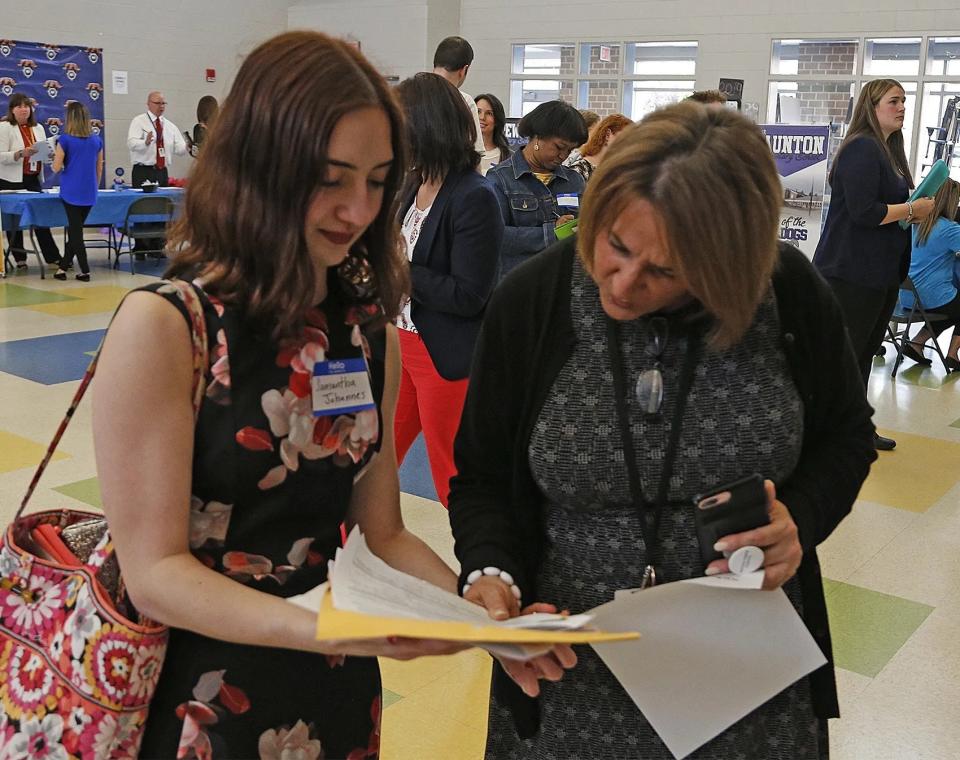 Director of Student Services and Transportation Kathy Perry, right, helps Samantha Johannes at Taunton Public Schools' teacher job fair held at the Elizabeth Pole school on Thursday, May 9, 2019.