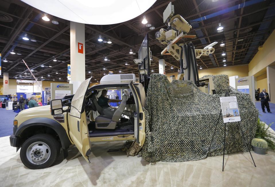 Exhibitors display products at the 8th annual Border Security Expo, Tuesday, March 18, 2014, in Phoenix. The two day event features panel discussions, sharing intelligence, and exhibitors displaying high-tech wares aimed at securing lucrative government contracts and private sales. (AP Photo/Matt York)