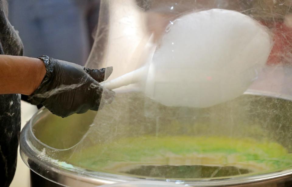 Laci King of Art of Sucre makes champagne-flavored cotton candy Monday, Feb. 27, 2023, in Fairlawn, Ohio.