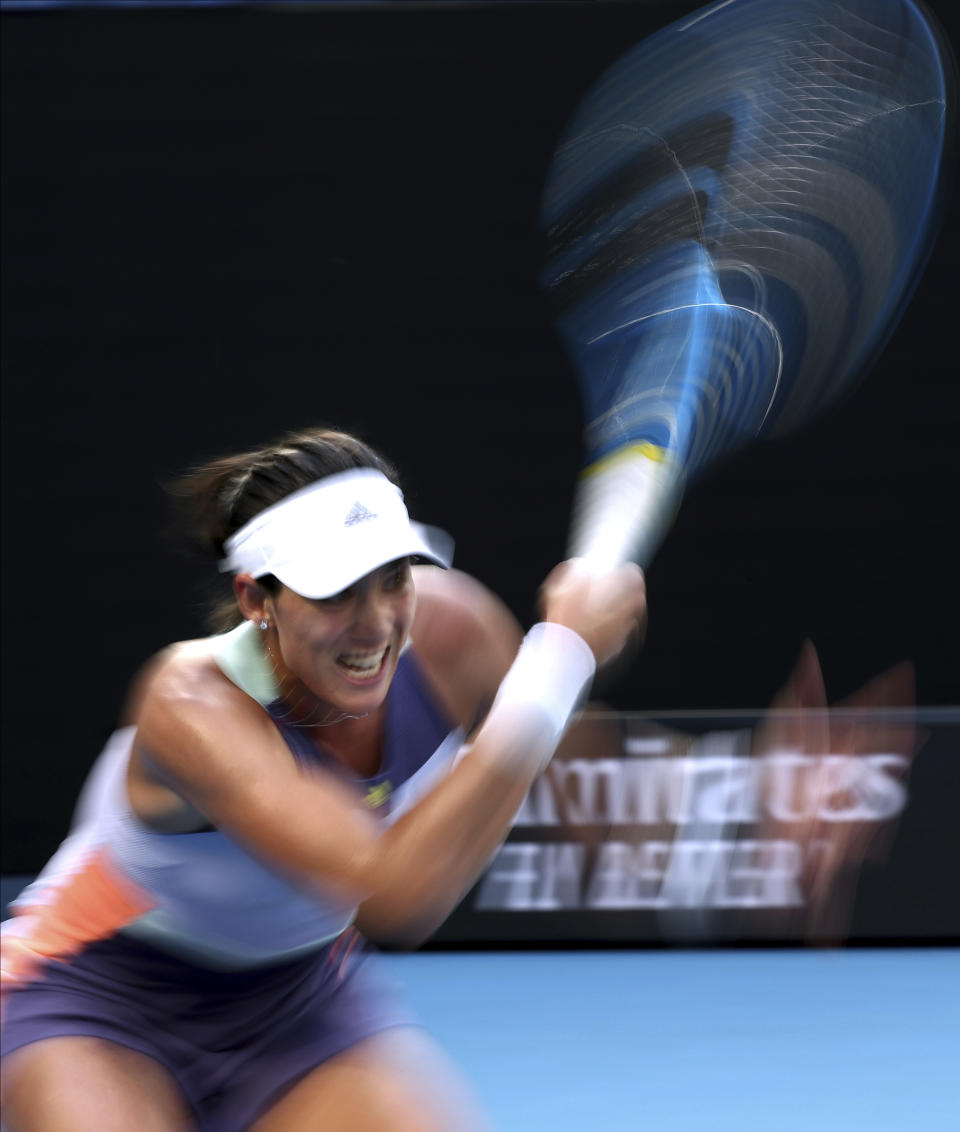 Spain's Garbine Muguruza makes a forehand return to Ukraine's Elina Svitolina during their third round singles match at the Australian Open tennis championship in Melbourne, Australia, Saturday, Jan. 25, 2020. (AP Photo/Dita Alangkara)