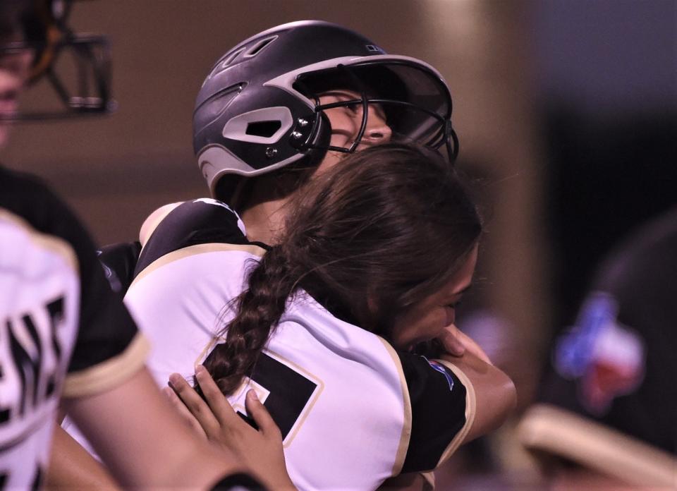 A Haskell player hugs Savanna Camacho after Camacho hit a two-run homer in the fourth inning of Game 2 against Stamford.